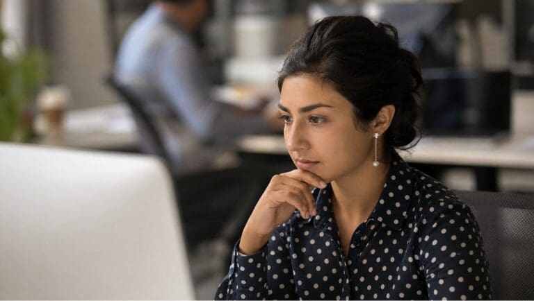 Marketing professional reviewing AI lead qualification results on screen