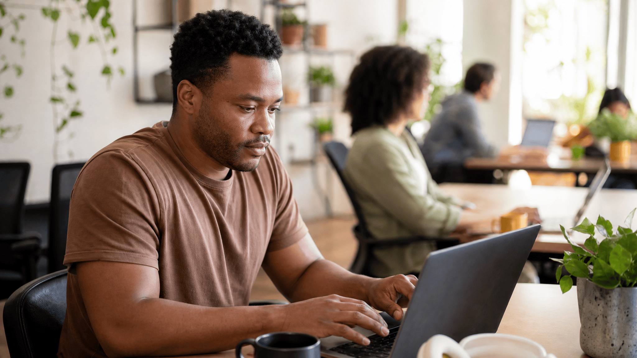 Person building a digital form on a laptop in a bright office