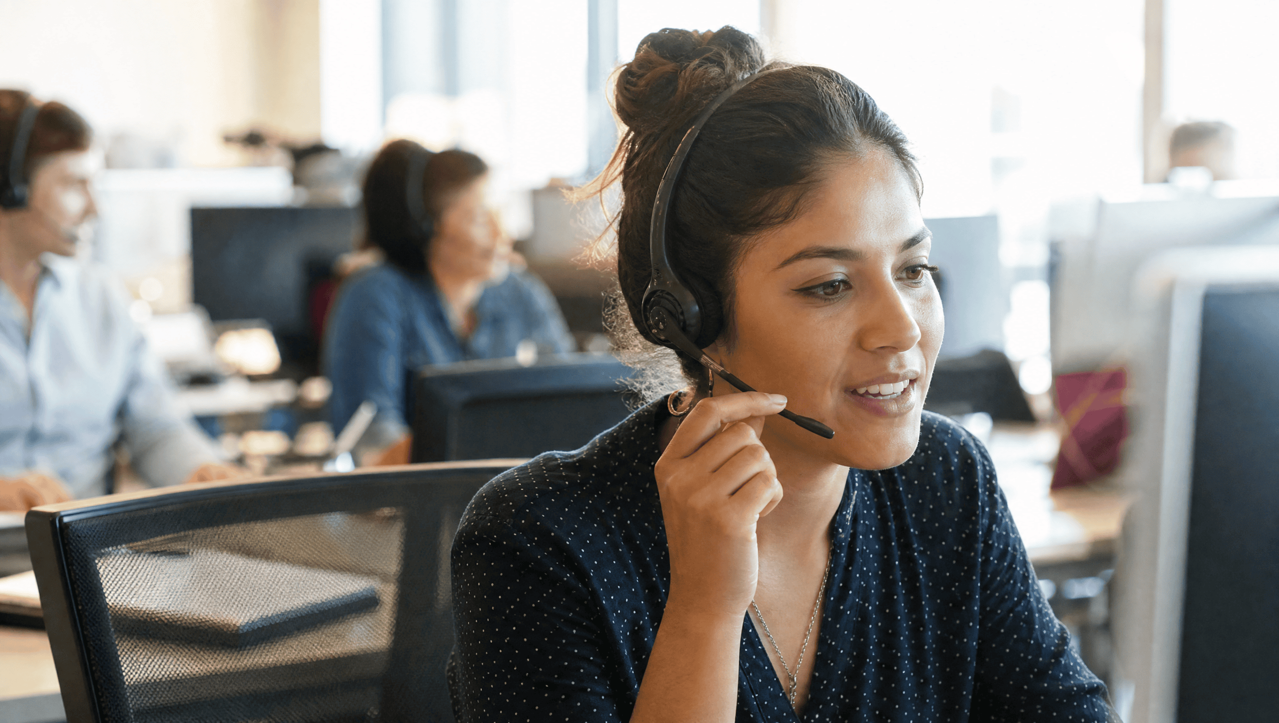 Call center agent with a headset on a call
