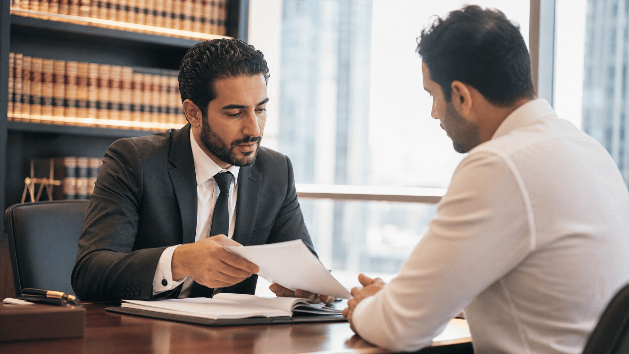 Lawyer reviewing documents with a client in a bright law office