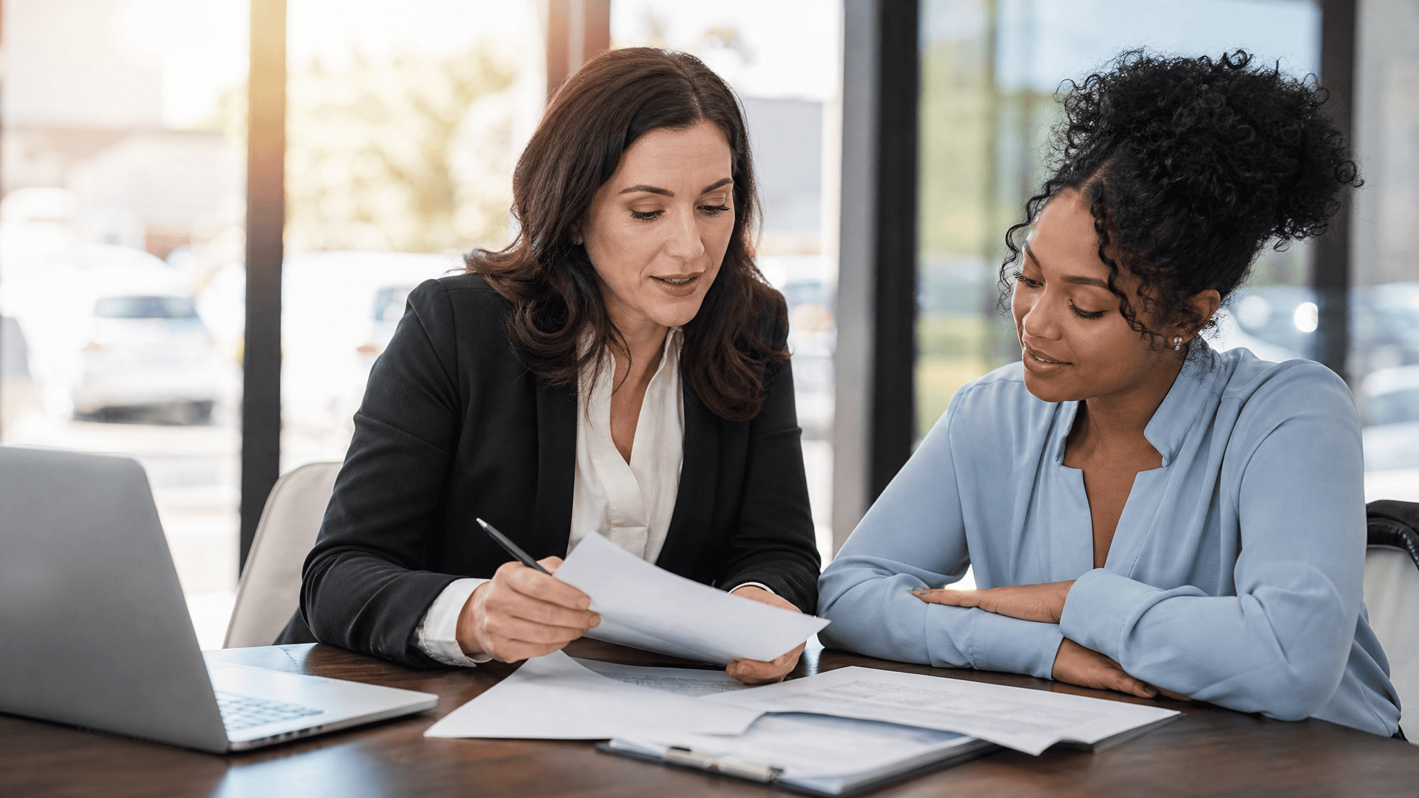 Insurance claims adjuster reviewing documents with a client
