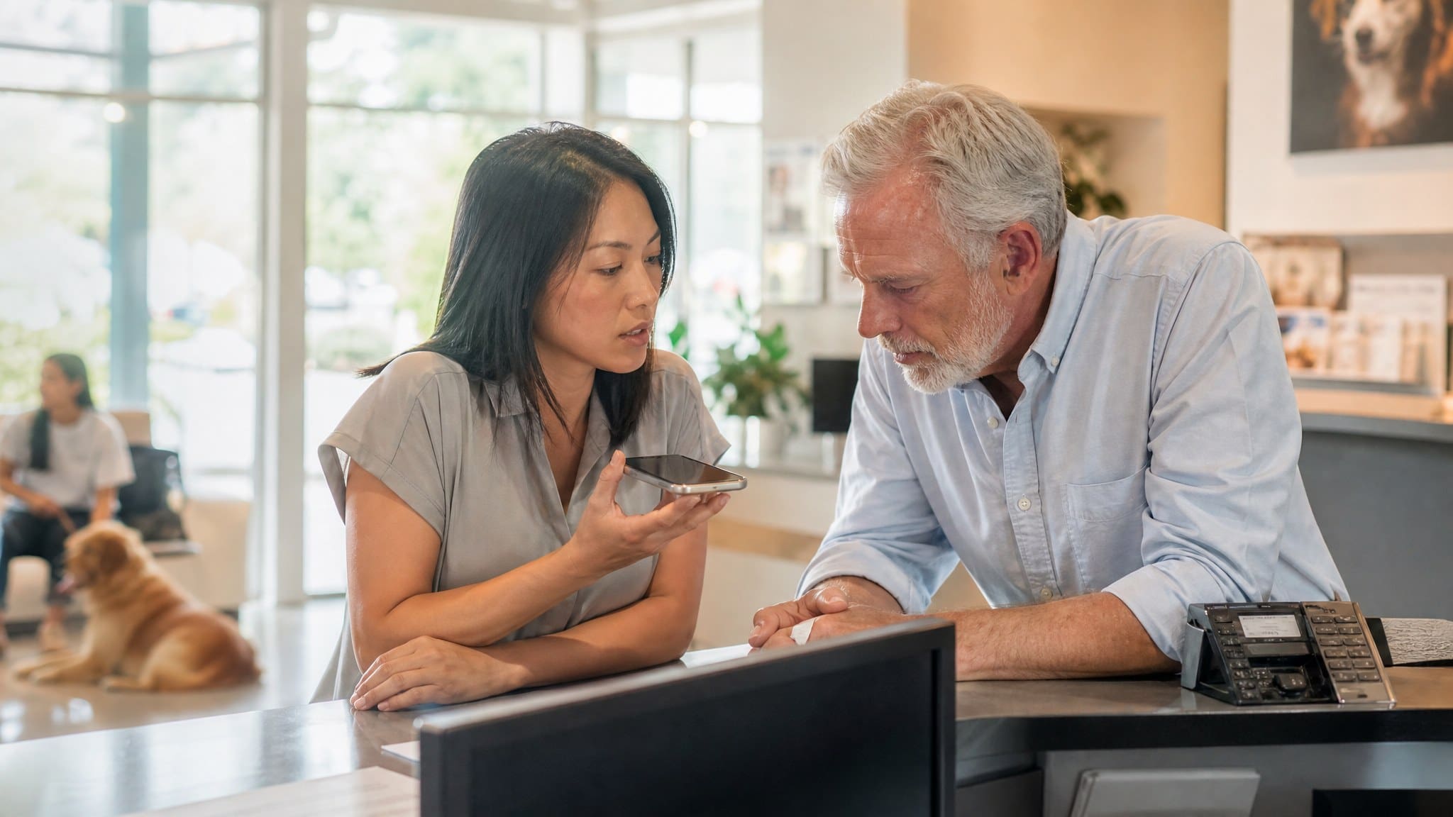 Clinic manager and owner testing their AI receptionist phone line at the front desk